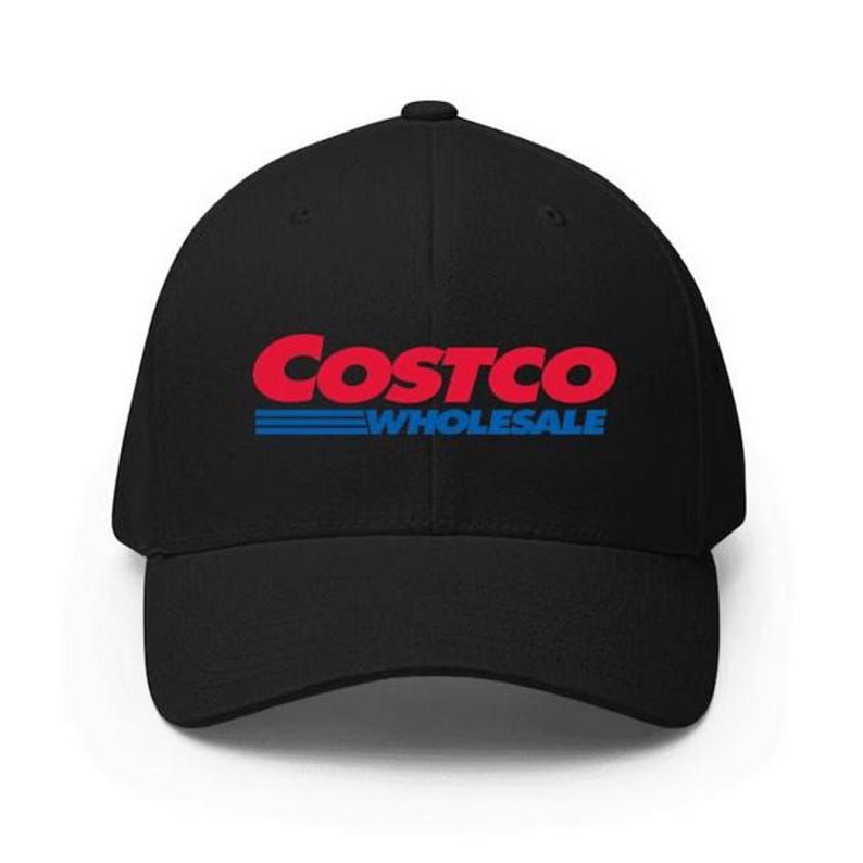 May include: Black baseball cap featuring the Costco Wholesale logo in red and blue. The logo is centered on the front of the cap. The hat has a curved brim and a structured fit.