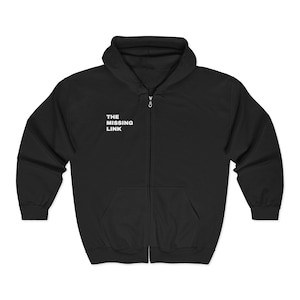 May include: Black zip-up hoodie with a hood and front pockets. The text "THE MISSING LINK" is printed in white on the upper left chest area. The hoodie is made of a soft material.