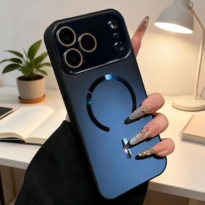 May include: A black and blue gradient phone case with a circular design. The case has a glossy finish and features cutouts for the phone's camera and buttons. The case is held by a person.