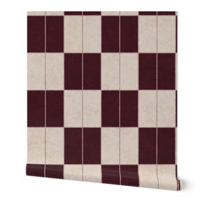 May include: A roll of wallpaper featuring a repeating geometric pattern of alternating dark burgundy and off-white rectangular blocks. The design consists of vertical pairs of rectangles arranged in a grid, with a subtle textured appearance.