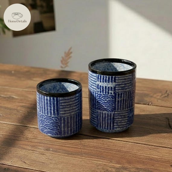 A small-batch Japanese wabi-sabi stoneware mug with moody blue-black glaze that looks like it came from a rural Kyoto kiln — 22 favorites at $100 suggests real desire.