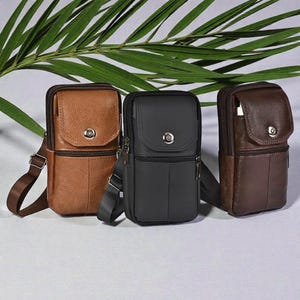 May include: Three leather crossbody bags in brown and black. Each bag features a flap closure with a metal button, a zipped compartment, and an adjustable shoulder strap. The bags are shown against a neutral background.