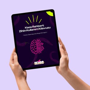 May include: A tablet displaying a book cover with the title "Kaos Rehberi: Zihin Kullanım Kılavuzu" in white text. The cover features a pink brain graphic with circuit board elements, and a logo that says "NEURO". The background is dark purple.