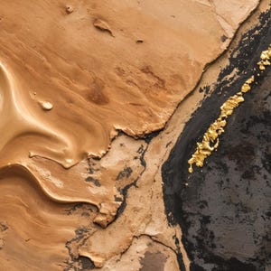 May include: An abstract painting featuring a thick, textured application of beige and tan paint on the left side, transitioning into a deep black section on the right, accented by a vertical line of metallic gold leaf flakes and textured gold paint.