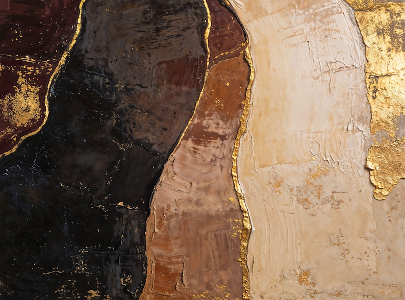 May include: An abstract painting featuring thick, textured layers of paint in deep black, dark burgundy, warm brown, and creamy beige. The distinct color sections are separated by irregular, raised lines of metallic gold leaf accents.