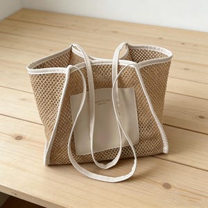 May include: A white ceramic mug with a black handle and the text "But First, Coffee" in a black, handwritten-style font. The mug is on a white surface.