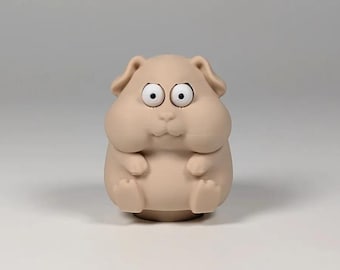 May include: A small, beige, matte-finished figurine of a round, chubby hamster with large, wide-set white eyes and black pupils. The creature has small ears, a tiny nose, and two small front paws resting on its belly, with a smooth, solid texture.