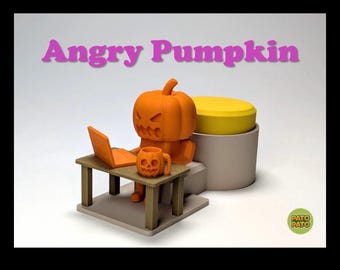 May include: A 3D printed figurine of an orange pumpkin-headed character sitting at a brown desk with an orange laptop and a small pumpkin mug. The text Angry Pumpkin is displayed above the figure, and a yellow circular object sits on a gray base.
