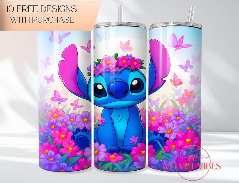 May include: A cylindrical tumbler featuring a blue alien character with large ears wearing a pink and purple flower crown, surrounded by pink and purple flowers and butterflies against a light blue sky background, with a clear straw and lid.