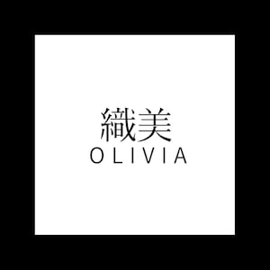 May include: A white square with the text "織美 OLIVIA" in black. The top text is in Japanese characters, and the bottom text is in a sans-serif font.