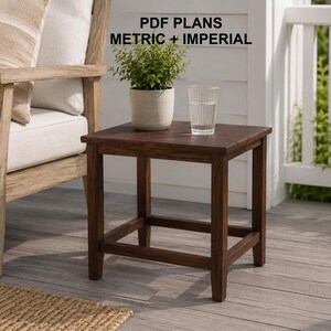 May include: A square dark brown wooden side table with four straight legs and a lower support frame. The text PDF PLANS METRIC + IMPERIAL is visible above the table. A small green potted plant and a clear glass of water sit on the tabletop.