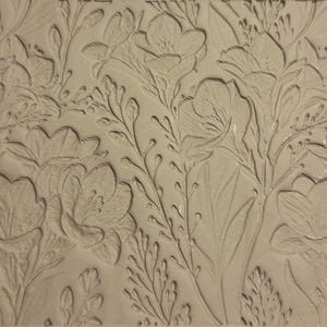 May include: A beige floral relief pattern showing detailed flowers, leaves, and stems. The design is embossed, creating a textured surface with varying depths and shadows. The overall aesthetic is natural and botanical.