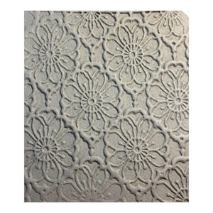 May include: A close-up shot of a light grey textured surface with a repeating floral pattern. The design features stylised flowers with detailed petals and a central circular element, creating a symmetrical and decorative effect. The pattern is embossed, giving it a three-dimensional appearance.