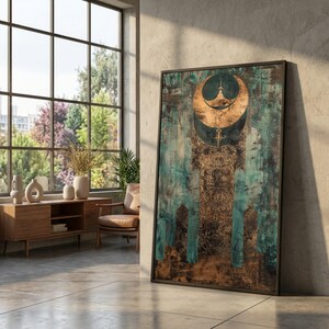 May include: Abstract art print featuring a teal and bronze color palette with a crescent moon design. The artwork has a textured appearance and is framed in a black border. The piece leans against a concrete wall, suggesting a modern interior.