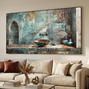 May include: An artistic wall painting depicting an aged, turquoise-toned interior scene. It features an arched doorway, a decorative sink with brass fixtures, and ornate vases. The painting is framed in black and hangs above a beige sofa.