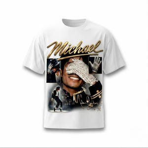 May include: White t-shirt featuring a gold script of the name "Michael" above a collage of images. The collage includes a portrait, a gloved hand, and a dancing figure. The shirt has a crew neck and short sleeves.