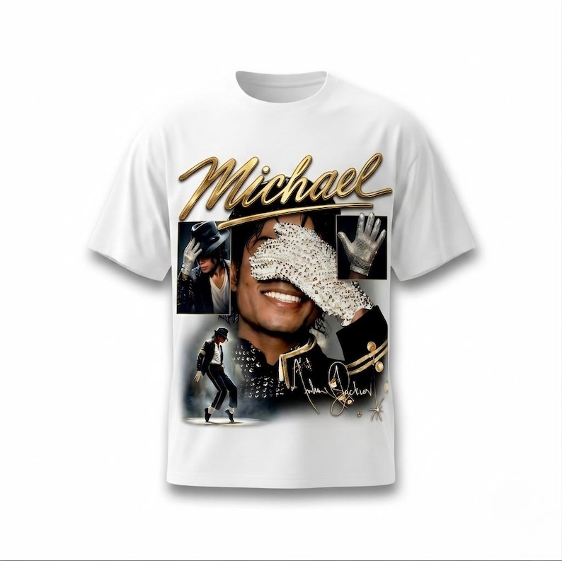 May include: White t-shirt featuring a gold script of the name "Michael" above a collage of images. The collage includes a portrait, a gloved hand, and a dancing figure. The shirt has a crew neck and short sleeves.