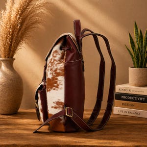 cowhide backpack
leather backpack
western backpack
cow print bag
hair on hide bag
boho backpack
western purse
leather rucksack
cowhide purse
rustic leather bag
travel backpack
backpack for her
handmade backpack