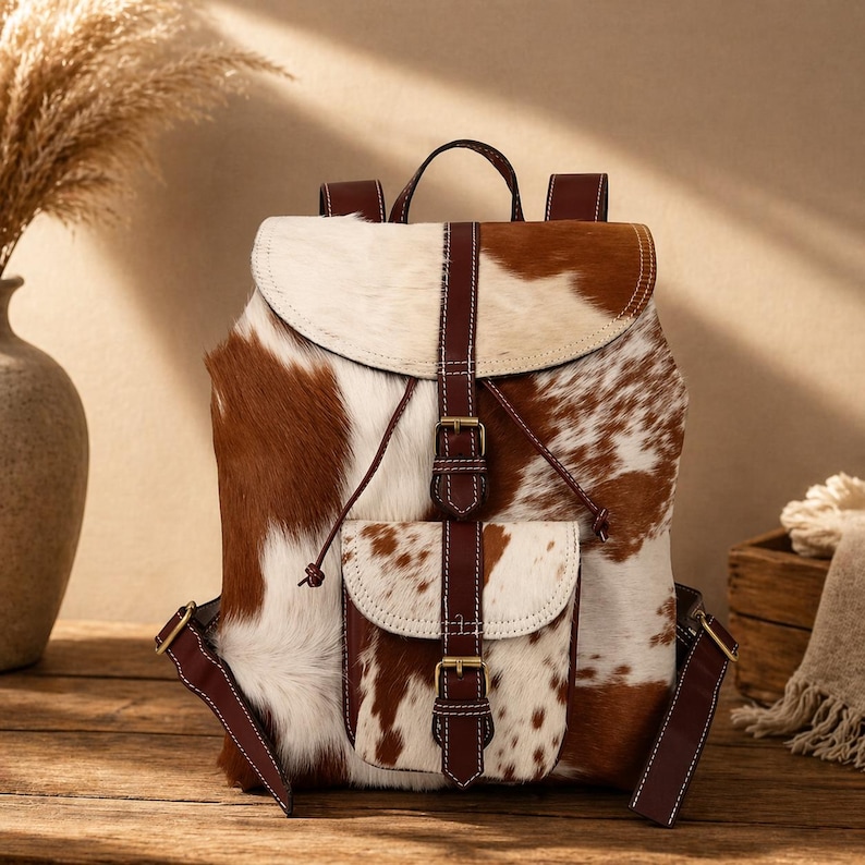 cowhide backpack
leather backpack
western backpack
cow print bag
hair on hide bag
boho backpack
western purse
leather rucksack
cowhide purse
rustic leather bag
travel backpack
backpack for her
handmade backpack