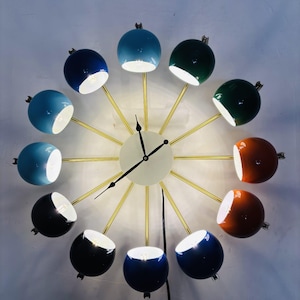 Reloj de pared Sputnik moderno con luces, decoración artística y colorida para el hogar.