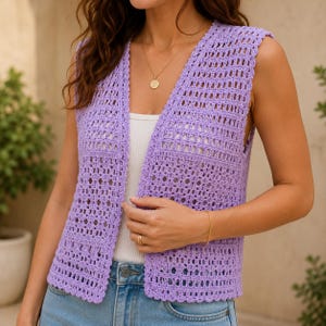 May include: A sleeveless lavender crochet waistcoat featuring an open-front design with a scalloped edge. The garment is crafted with a repeating geometric pattern of vertical columns and horizontal bands, worn over a white ribbed top and blue denim jeans.