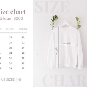 May include: A white Gildan 18000 sweatshirt displayed on a hanger with a size chart showing measurements in inches. The chart lists sizes S through 4XL with corresponding length and width dimensions, and arrows indicate how to measure the garment.