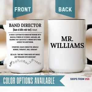 May include: A white ceramic mug with a black handle and interior. The front features black text defining a band director with phonetic spelling, synonyms, and a musical staff. The back displays the black text MR. WILLIAMS in a bold serif font.