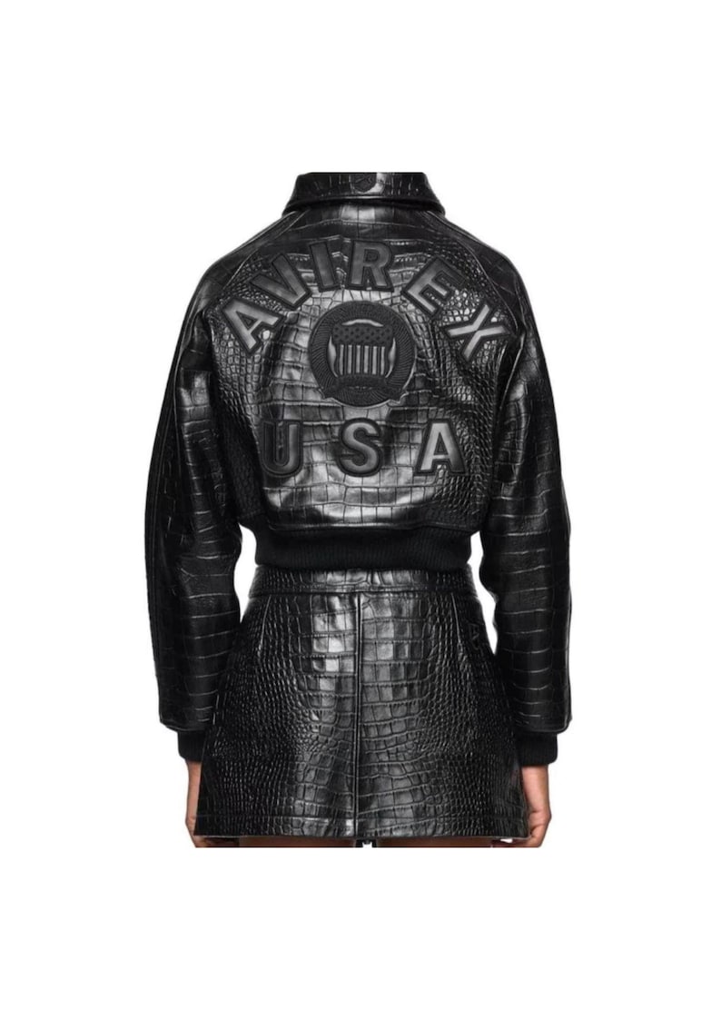 May include: Black leather jacket and skirt set with a crocodile texture. The jacket features the text "AVIREX USA" embossed on the back. The set includes a bomber-style jacket and a mini skirt.