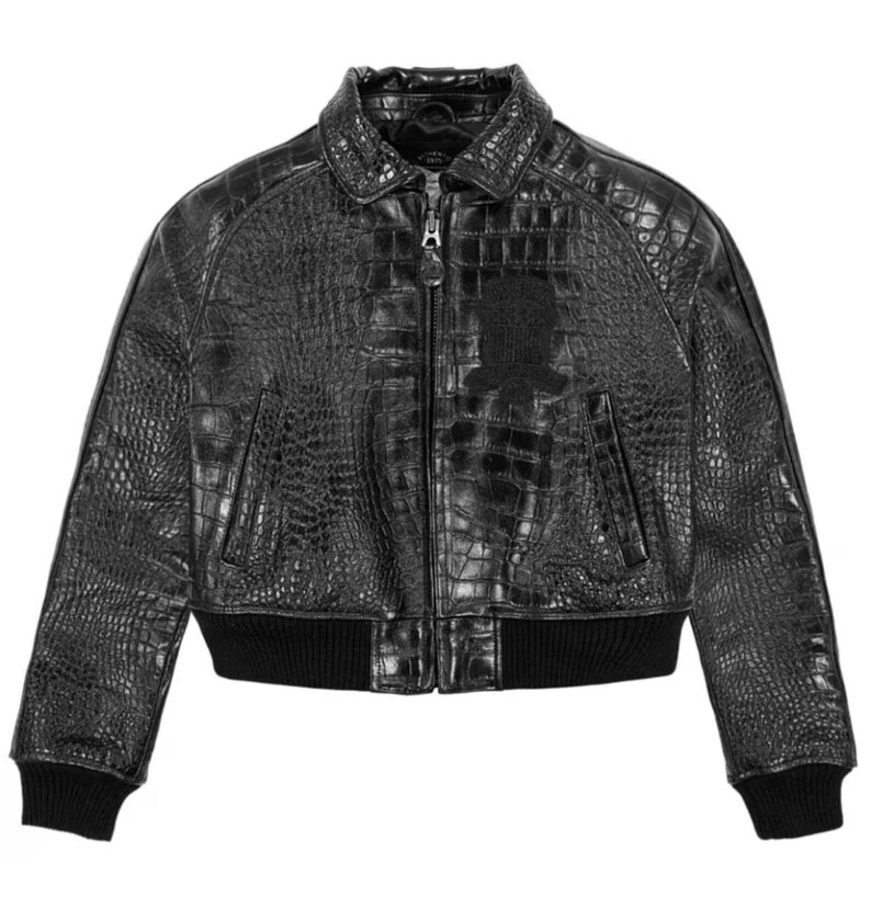 May include: Black leather bomber jacket with a crocodile skin texture. The jacket features a zip-up front, a collar, and a black ribbed hem and cuffs. A small emblem is on the chest.