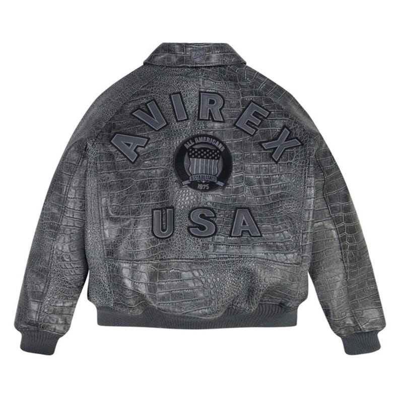 May include: A gray leather bomber jacket with a crocodile skin texture. The back of the jacket features the brand name "AVIREX" arched across the top, with "USA" below a patch that says "ALL AMERICAN ESTABLISHED 1975".