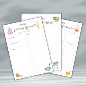 May include: Three white recipe and planning notepads with watercolor illustrations of food and kitchen items. The notepad on the left says "Meine Lieblings-Rezepte" and has space for recipe name, prep time, and ingredients. The center notepad says "Einkaufsliste". The right notepad says "Mein Wochenplan".
