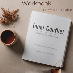 May include: A workbook titled "Inner Conflict" with the subtitle "Understanding Self-Sabotage." The cover is white with black text and a yellow and gold corner design. A small wooden cup and dried plant are next to the book.