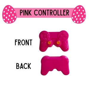 K&ouml;nnte beinhalten: Ein leuchtend rosa Controller, von vorne und hinten gezeigt, mit zwei orangefarbenen Kn&ouml;pfen. Der Text "PINK CONTROLLER" steht &uuml;ber dem Controller, mit rosa Osterei-Grafiken auf beiden Seiten.