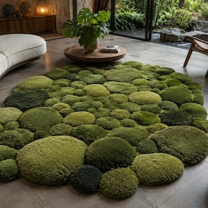 May include: An oval-shaped area rug featuring a textured, three-dimensional design composed of numerous circular, moss-like tufted elements in varying shades of green, ranging from light lime to deep forest tones, creating a dense, organic surface.