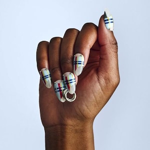 May include: A set of three ceramic mugs with a speckled, matte finish in cream, light grey, and dark grey. Each mug has a simple, minimalist design, ideal for tea or coffee.