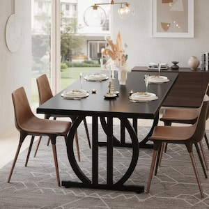 May include: A modern dining room set featuring a black rectangular table with a unique base design, surrounded by six brown chairs. The table is set with plates, silverware, and candles, creating an elegant atmosphere. A decorative chandelier hangs above.
