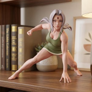 May include: A figurine of a character with light purple hair and a red diamond mark on the forehead, wearing a sleeveless olive green top. The figure is in a dynamic crouching pose with one hand on the ground and the other arm pulled back.