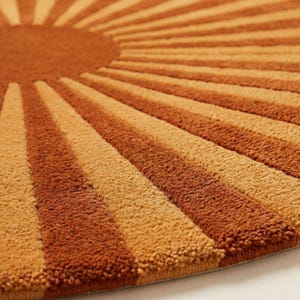 terracotta and golden hues, creating a retro-inspired aesthetic. Positioned on a wooden floor near large windows, the natural