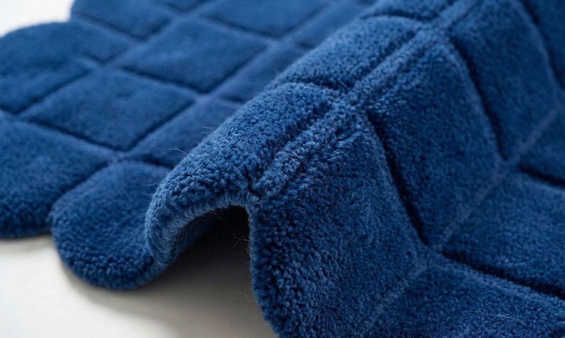 texture and contemporary pattern that adds elegance and comfort to modern home decor. The deep navy blue color of the rug creates a bold statement while blending