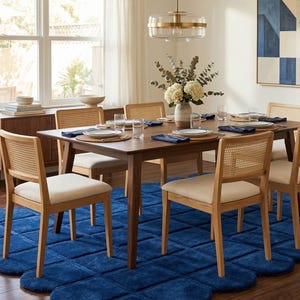 beautifully with minimalist and Scandinavian style interiors. The rug is shown under a wooden coffee table in a sunlit living room with a neutral sofa, warm wooden flooring,