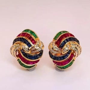 May include: A white ceramic mug with a black handle and the text "But First, Coffee" in a black, bold font. The mug is on a white surface.