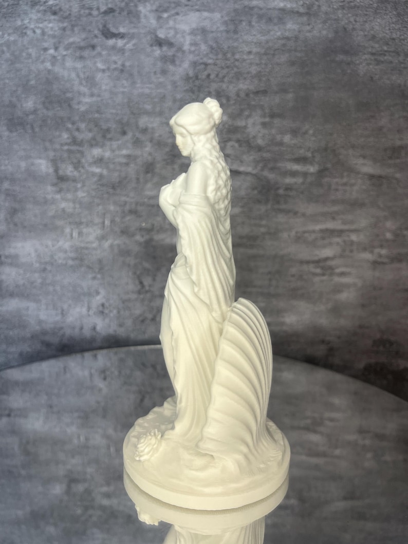 Opposite side angle
Elegant side angle of Venus statue inspired by Aphrodite, goddess of love and beauty. White mythology sculpture with shell symbolism, altar decor, feminine aesthetic home decor, spiritual figurine, romantic decor piece, mythology inspired shelf styling, detailed 3D printed statue, minimalist Greek goddess art.