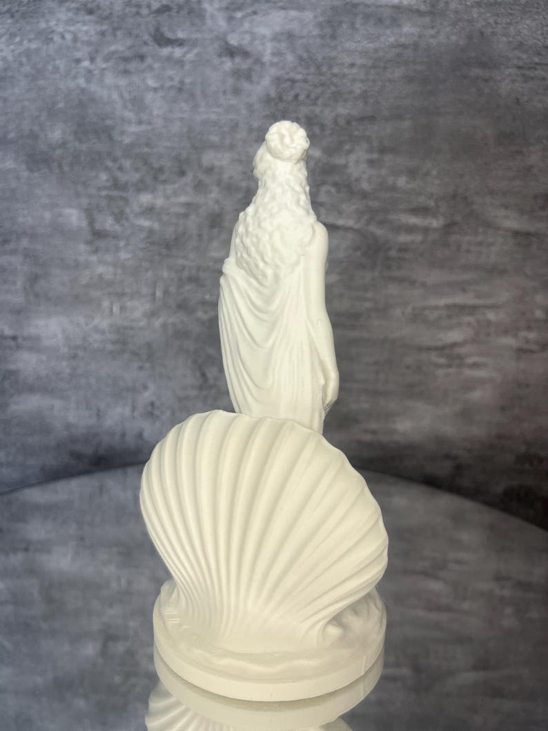 Back view
Back view of Venus goddess figurine displaying detailed hair, flowing fabric, and shell design. Aphrodite inspired mythology sculpture for feminine decor, spiritual altar styling, shelf decoration, romantic mythology art, white PLA statue, aesthetic home accessory, divine feminine symbolism, Greek and Roman mythology decor.