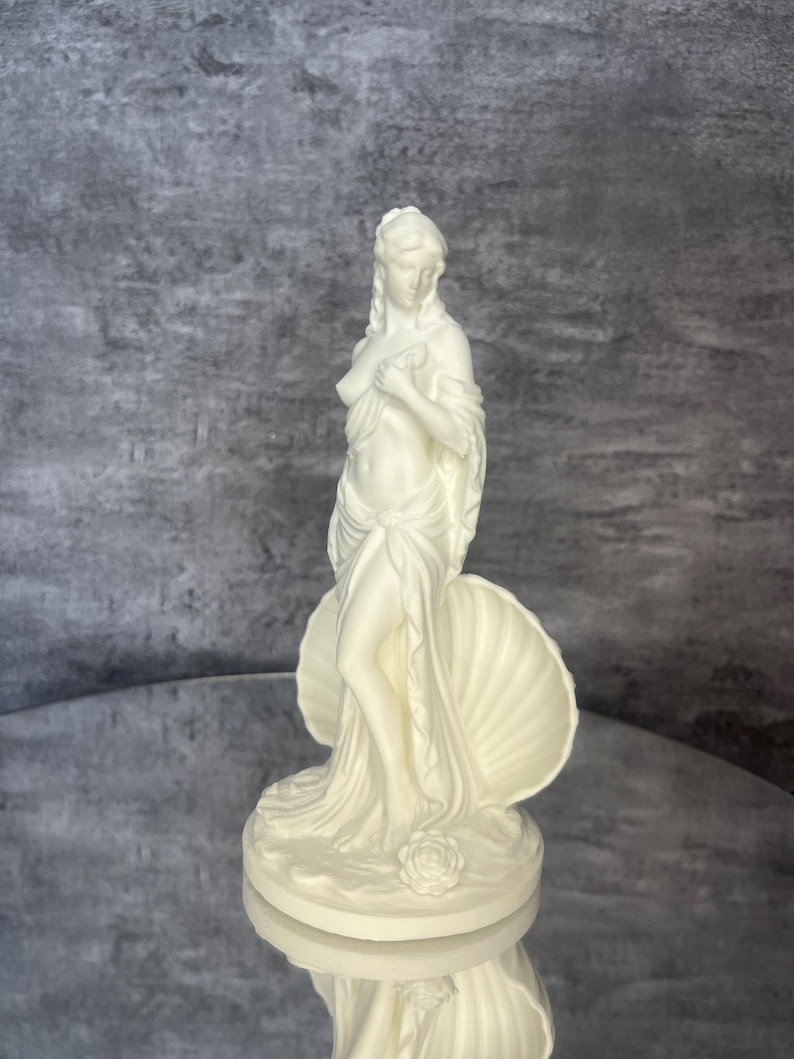 Final front angle / close perspective
Detailed front angle of Venus / Aphrodite figurine featuring graceful feminine pose and shell symbolism. Greek and Roman mythology inspired decor, white goddess sculpture for altars, shelves, vanities, spiritual spaces, divine feminine decor, romantic home styling, mythology gift, aesthetic PLA statue, elegant collectible artwork.