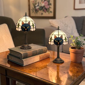 May include: A set of three ceramic mugs with a speckled, matte finish in cream, light grey, and dark grey. Each mug has a simple, minimalist design and a rounded handle.