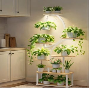 May include: A multi-tiered plant stand with several potted plants. The stand has a white frame with wooden shelves and built-in lighting. The plants are various shades of green, and the pots are white. The stand is against a neutral wall.