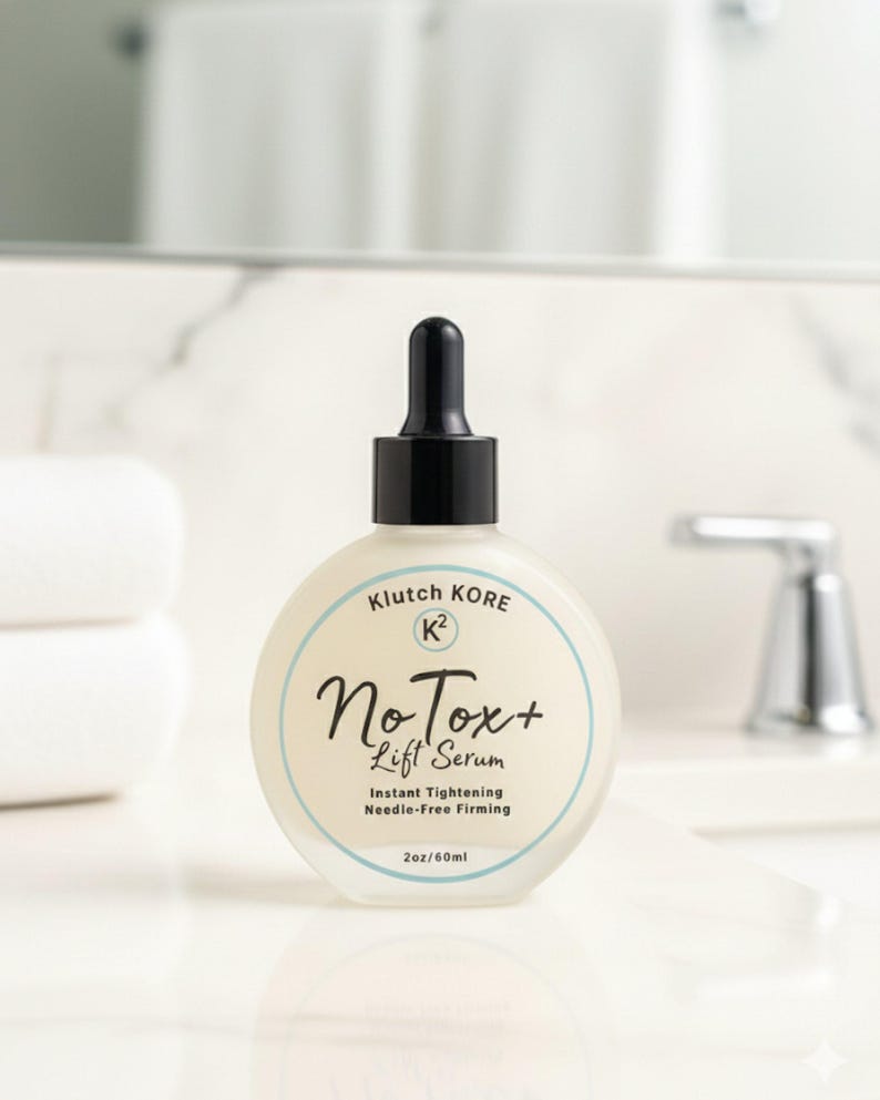 May include: A round, frosted glass bottle of No Tox+ Lift Serum with a black dropper top. The label features the text "Klutch Kore" and "No Tox+ Lift Serum". The bottle contains 2oz/60ml of product.