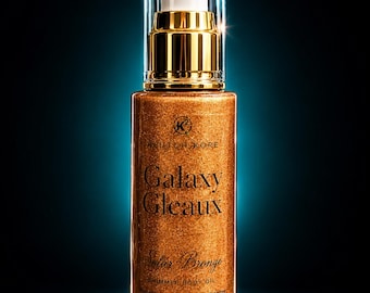 May include: A cylindrical glass bottle of Klutch Kore Galaxy Gleaux shimmer body oil in Solar Bronze. The bottle features a gold pump dispenser with a clear cap, containing 60 ml of golden liquid with visible shimmer particles.