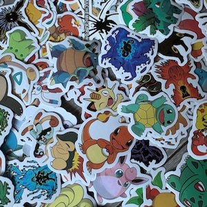 May include: A collection of assorted die-cut vinyl stickers featuring various colorful cartoon creatures, including Pikachu, Charmander, Squirtle, and Bulbasaur, with a central white rectangular sticker displaying the black text MYCHEMICALROM.