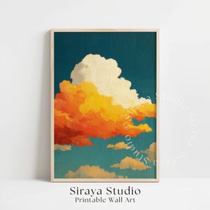 May include: A framed print featuring a vibrant cloudscape. The artwork showcases a large, fluffy cloud in shades of orange and yellow against a deep teal sky. The print is labeled "Siraya Studio Printable Wall Art."